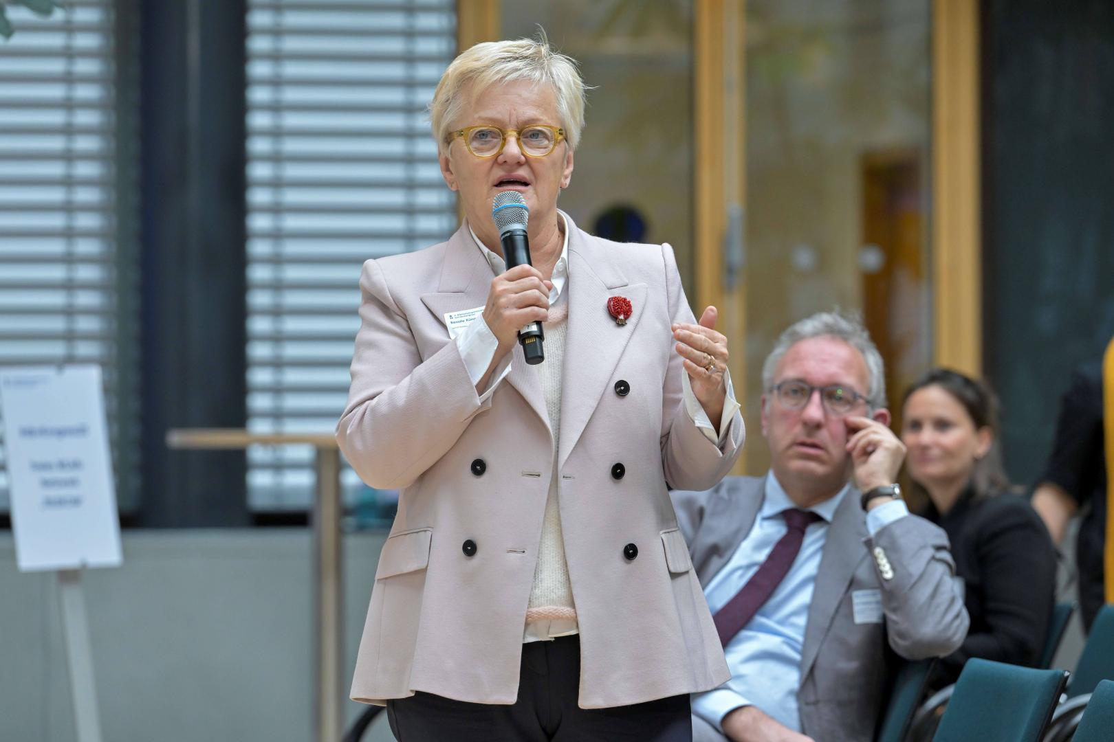 Eine Frau spricht in ein Mikrofon.